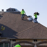 Hauling Shingles up the roof for Alpha Roofing Roof Replacement in Round Rock, TX