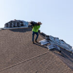 Hauling Shingles up the roof for Alpha Roofing Roof Replacement in Round Rock, TX